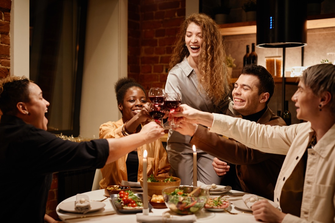 Friends clinking glasses at dinner