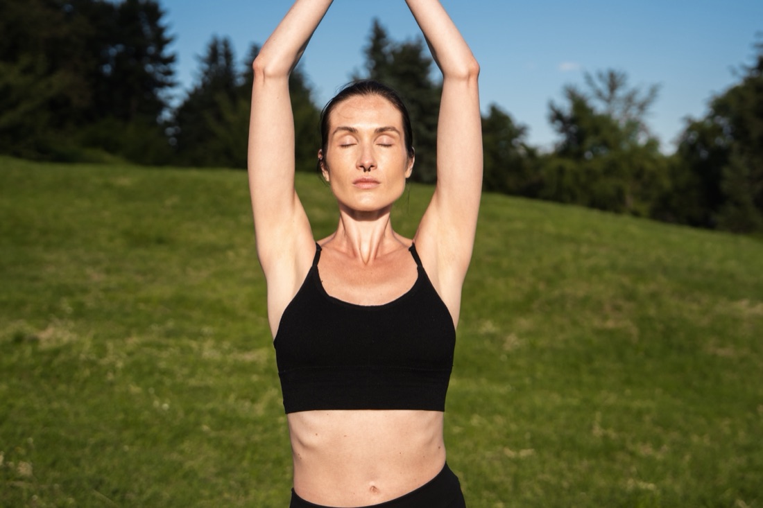 Morning yoga in a green field